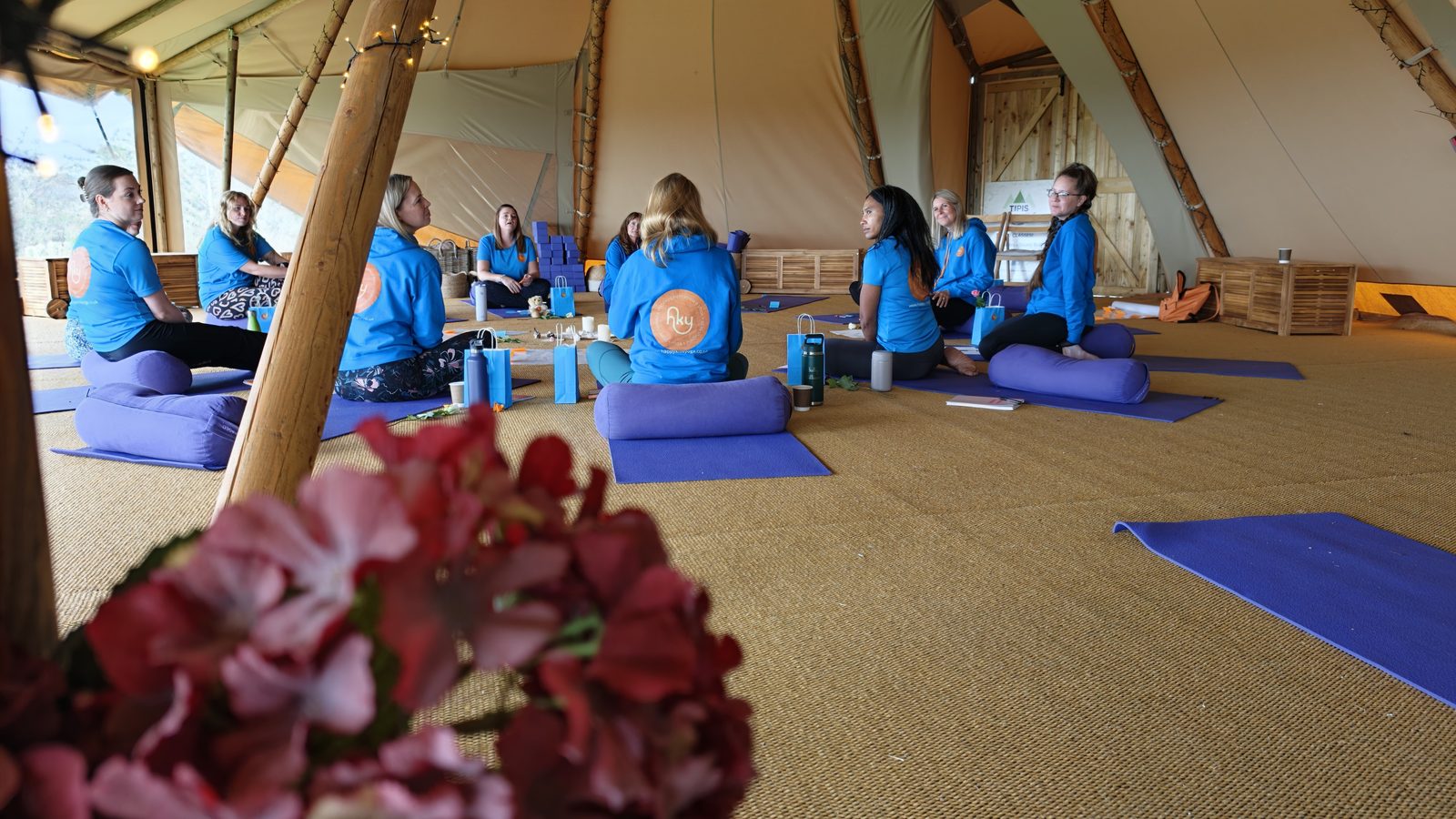Happy Kids Yoga franchisees sitting together on mats inside the tipi at Primrose Hill
