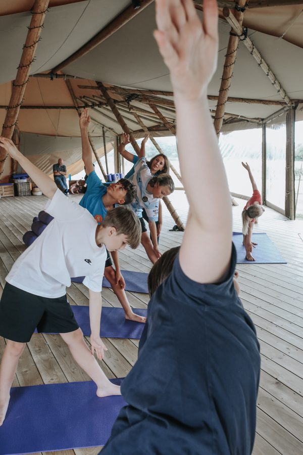 A class stretching their arms up high