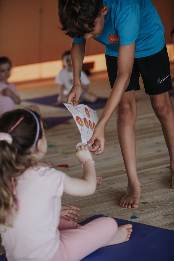 A teacher showing a little girl a sensory toy