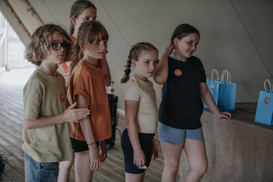 Children lined up with their Happy Kids Yoga goody bags